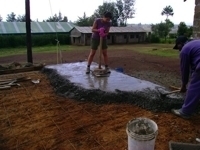 Helping to lay the concrete on the floor